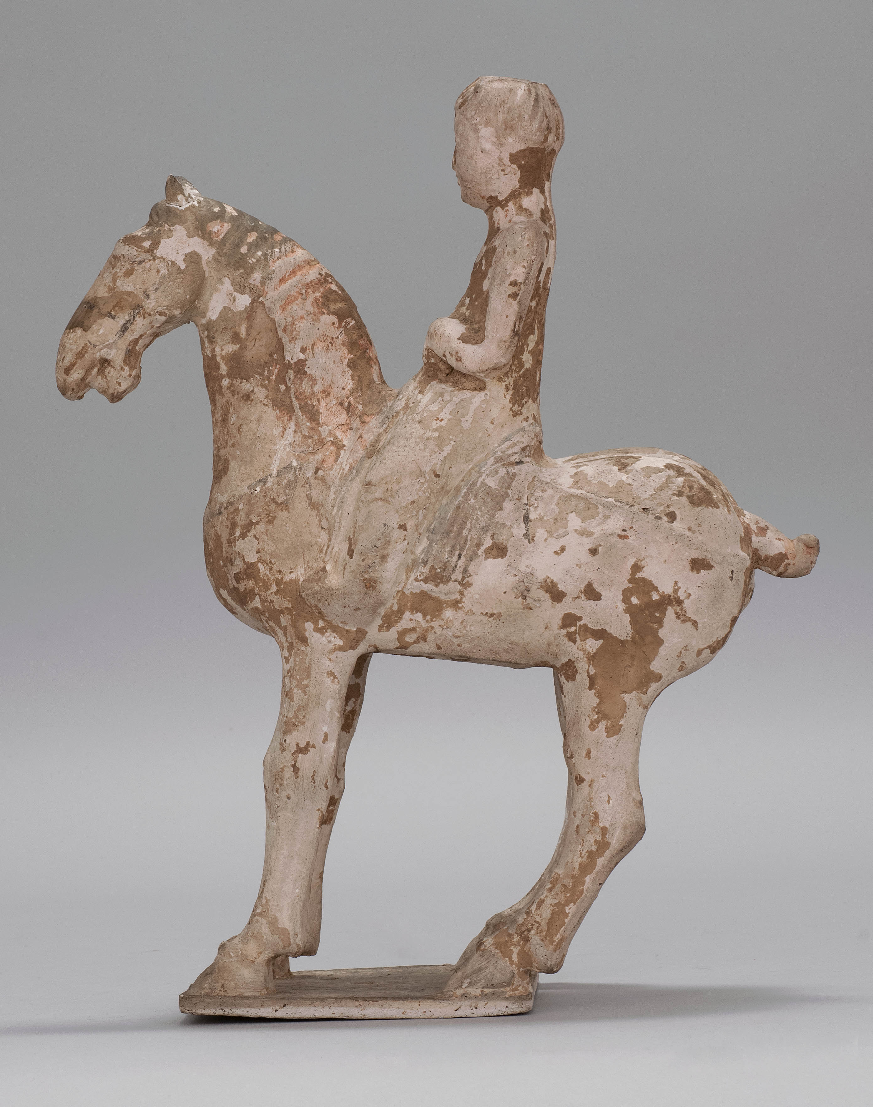 Appraisal: POTTERY HORSE AND RIDER Tang DynastyDepicting the horse standing on