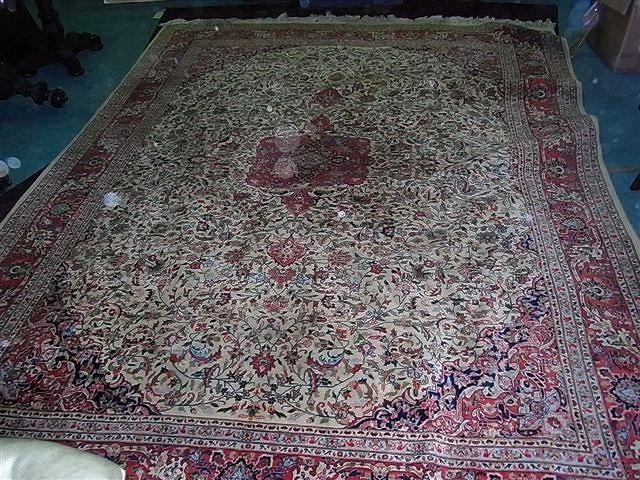 Appraisal: A LARGE INDIAN IVORY GROUND CARPET with central red medallion