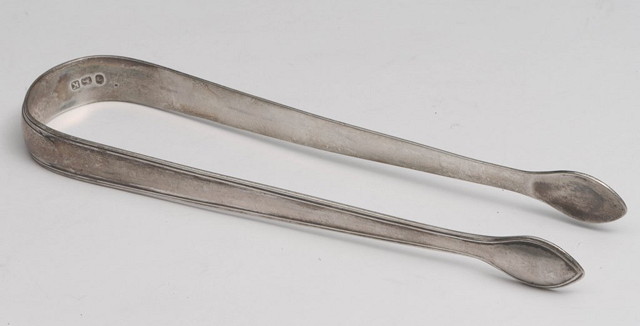 Appraisal: A PAIR OF GEORGIAN SILVER SUGAR TONGS with reeded decoration