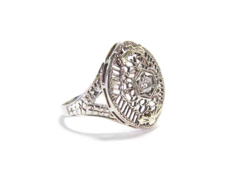 Appraisal: A white gold filigree ring with yellow gold accents and