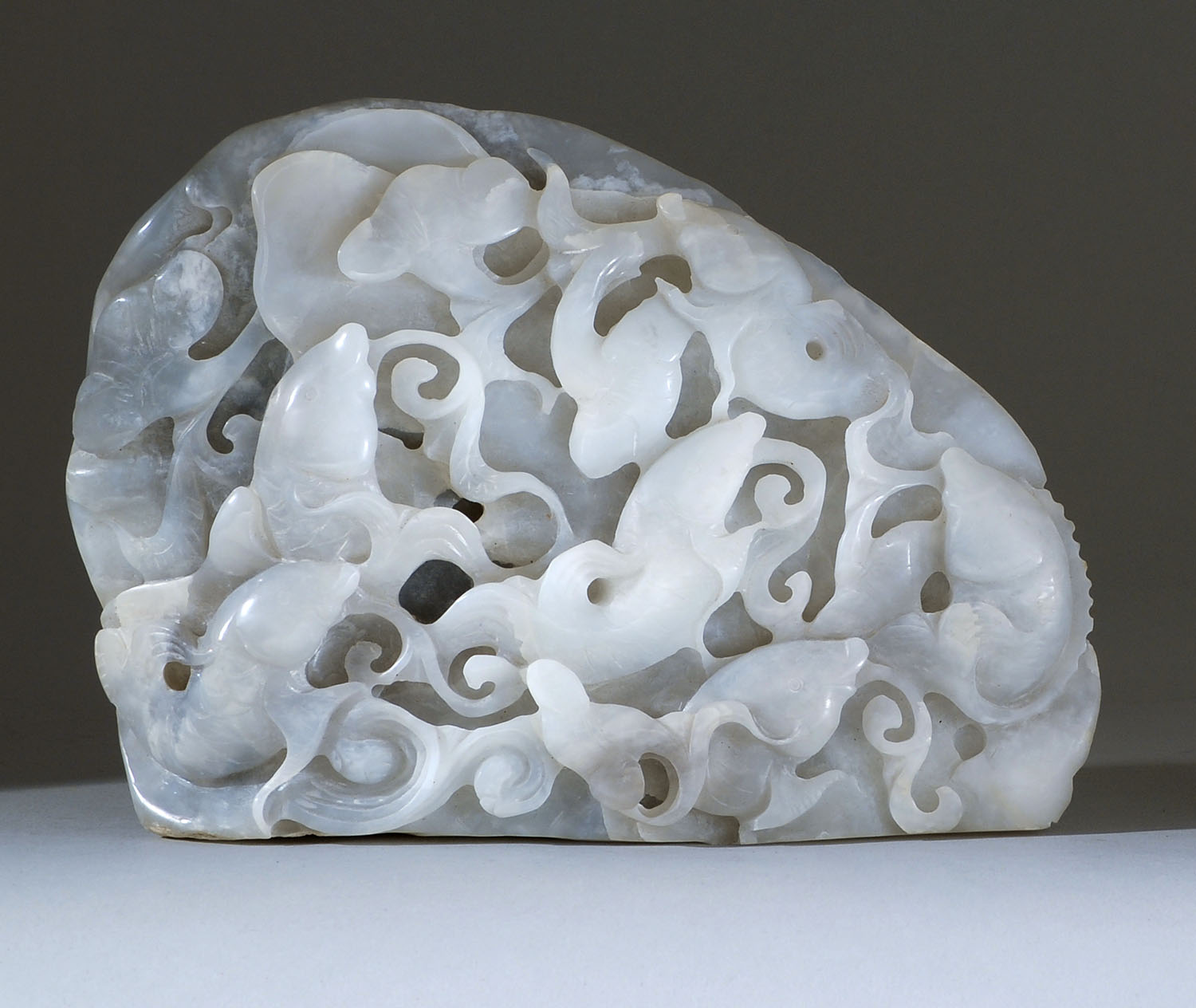 Appraisal: GRAY AND WHITE JADE CARVING In mountain form with carp