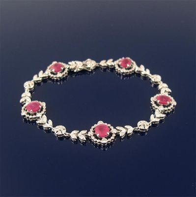 Appraisal: A ruby and diamond bracelet mounted with five oval shaped