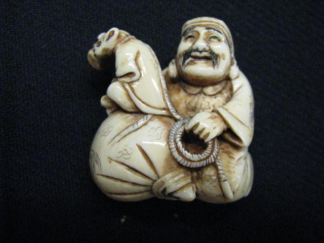 Appraisal: Carved Ivory Netsuke of man with Sack and dressed monkey