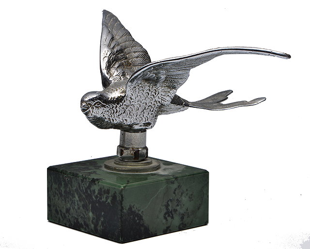 Appraisal: A SILVERED CAR MASCOT in the form of a swift