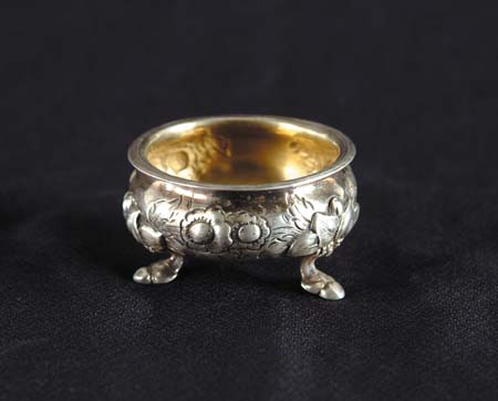 Appraisal: SILVER OPEN SALT Repousse work of flowers in a kettle