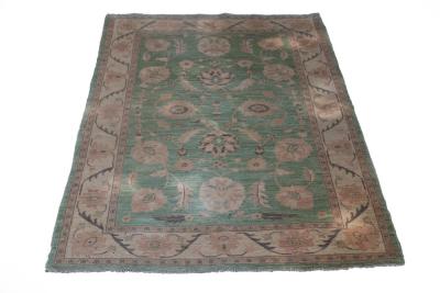 Appraisal: A rug of Persian design the lime green ground decorated