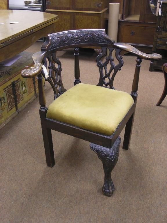 Appraisal: A Victorian Chippendale mahogany corner fitting elbow chair with twin