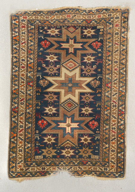 Appraisal: AN OLD CAUCASIAN BLUE GROUND RUG decorated a central multiple