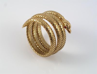 Appraisal: A yellow gold coiled snake bangle with realistically formed scales