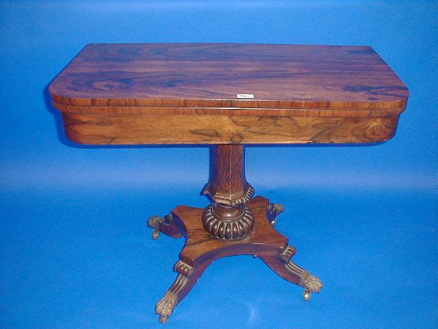 Appraisal: A Regency rosewood card table with rounded rectangular folding top