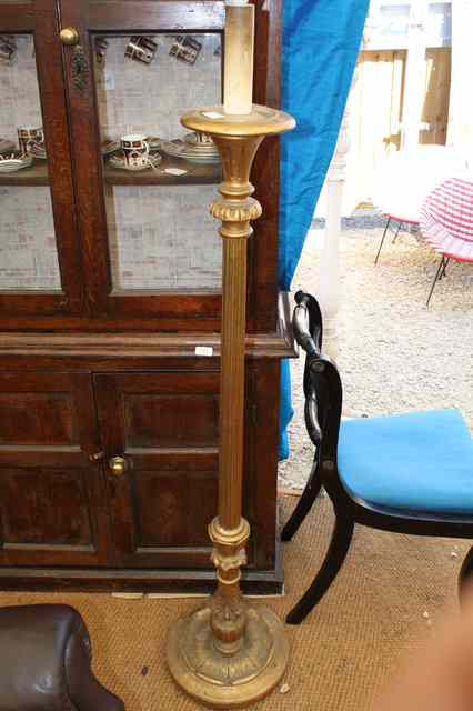 Appraisal: A GILT CARVED WOOD TORCHERE of fluted column form an