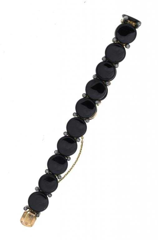 Appraisal: A FRENCH DIAMOND AND ONYX BRACELET with a line of