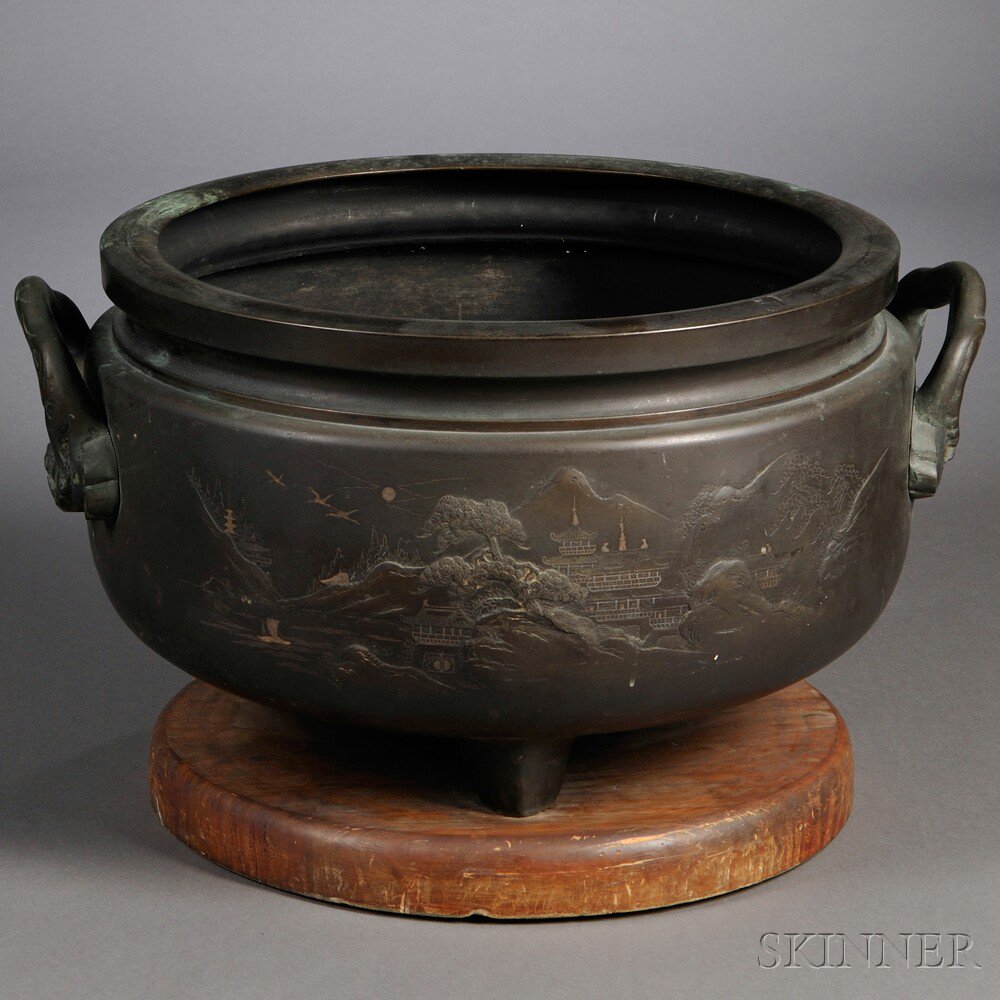 Appraisal: Bronze Tripod Jardiniere Japan th century decorated with landscape scenes