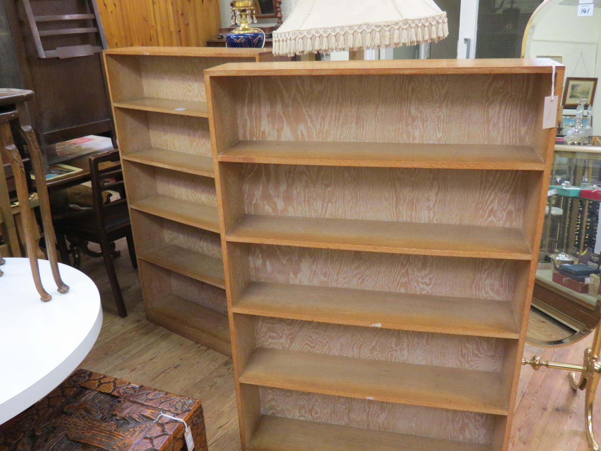 Appraisal: A pair of solid light oak open bookcases each with