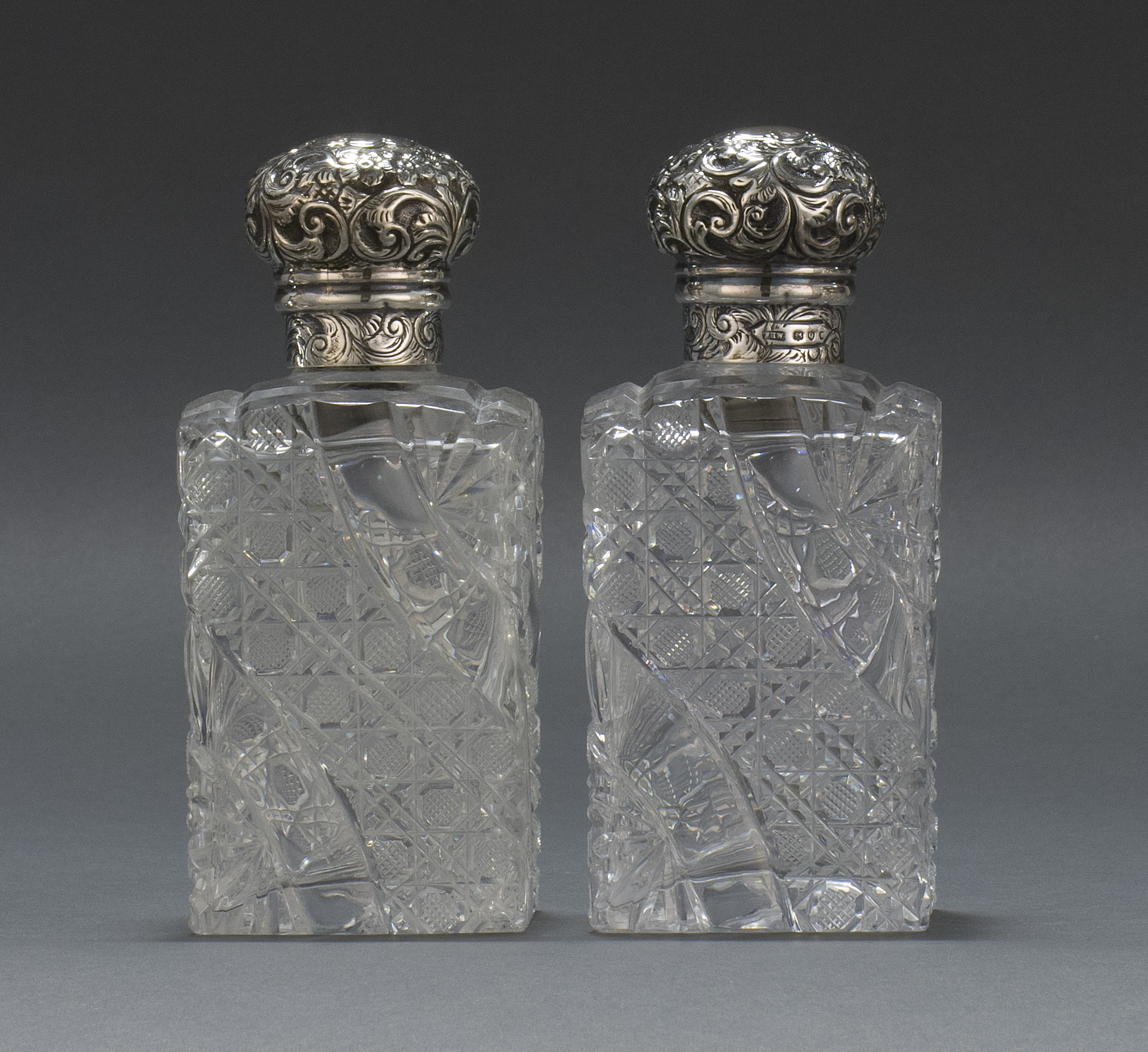 Appraisal: PAIR OF CLEAR CUT GLASS COLOGNE BOTTLES First Quarter of