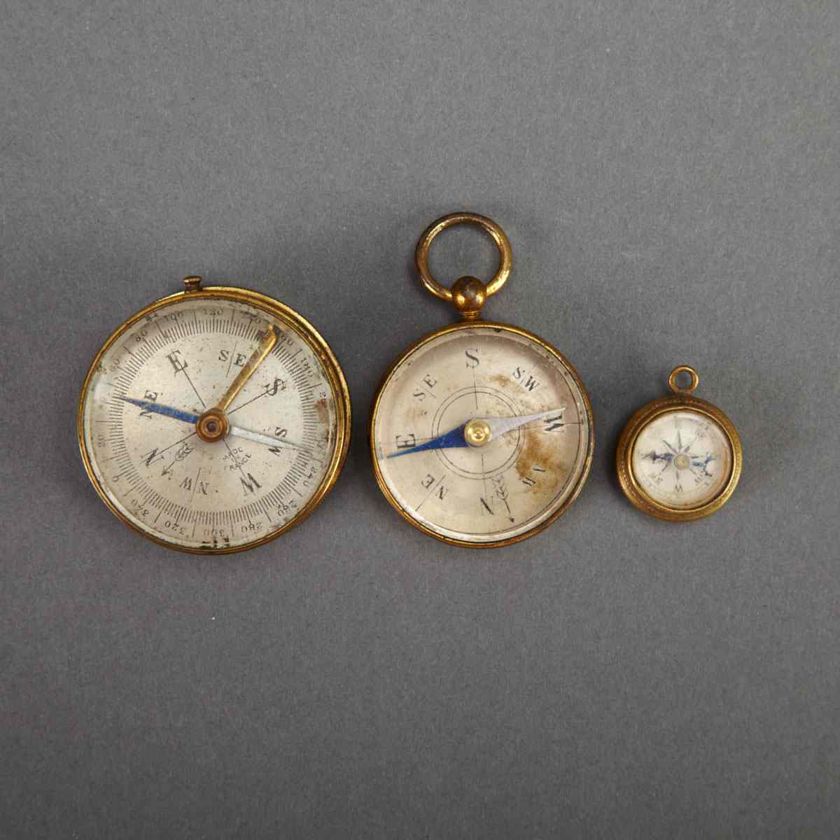 Appraisal: Two French Lacquered Brass Pocket Compasses and a Fob Compass