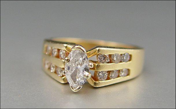 Appraisal: MARQUIS BRILLIANT DIAMOND RING K yellow gold ring featuring an