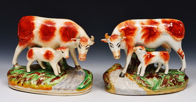 Appraisal: Pair of Staffordshire pottery models of cows and calveseach on