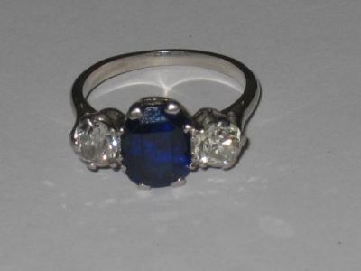 Appraisal: A SAPPHIRE AND DIAMOND THREE STONE RING the oval cut