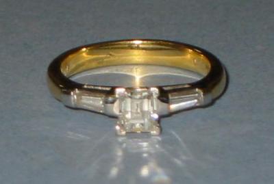 Appraisal: A SOLITAIRE DIAMOND RING the emerald cut stone with faceted