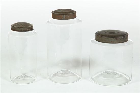 Appraisal: THREE BLOWN GLASS CANISTERS American th century With tin lids