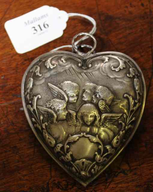 Appraisal: A SILVER HEART SHAPED CLIP with embossed cherub decoration London