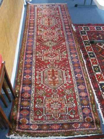 Appraisal: Heriz Persian Handmade Runner elaborate geometric designs floral trim red