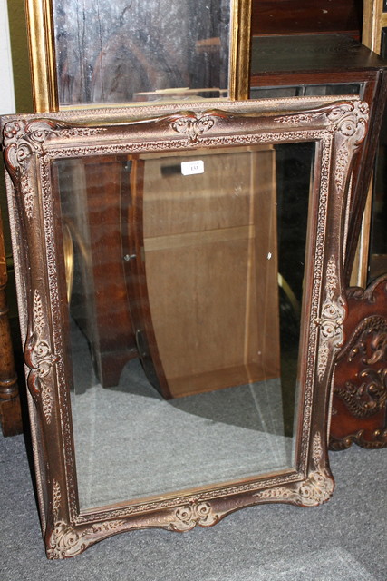 Appraisal: A GILT FRAMED MIRROR with relief frame