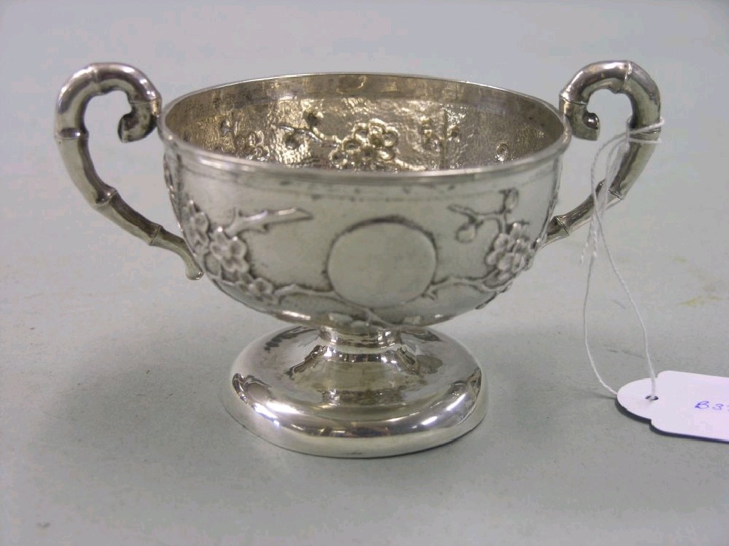 Appraisal: A Chinese silver two-handled bowl embossed with prunus blossom on