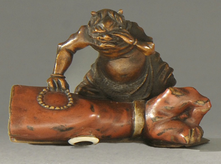 Appraisal: POLYCHROME WOOD NETSUKE Early th CenturyDepicting an oni mourning the