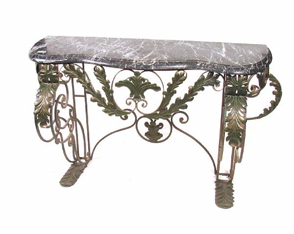 Appraisal: A wrought iron and tole polychrome console with marble top