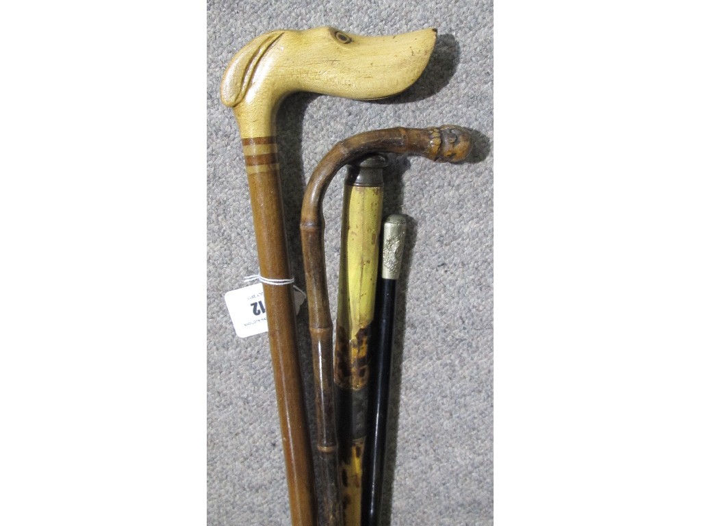 Appraisal: Lot comprising three walking sticks one dog's head handle and