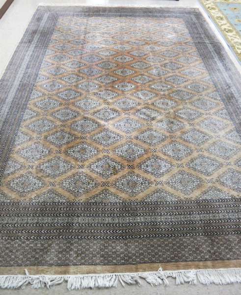 Appraisal: HAND KNOTTED ORIENTAL CARPET Indo-Bokhara featuring a field of repeating