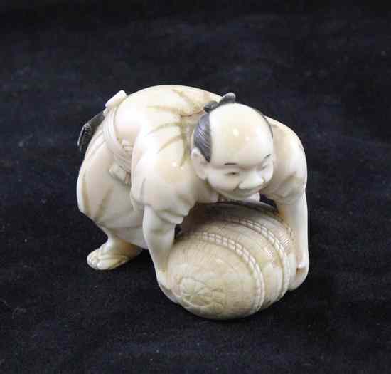 Appraisal: A Japanese walrus ivory figure of a man lifting a