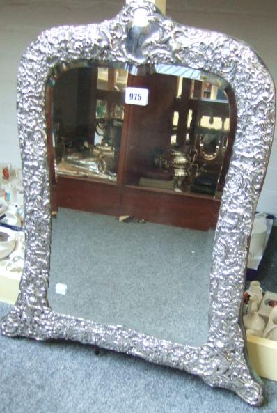 Appraisal: A silver mounted large shaped rectangular strut backed mirror the