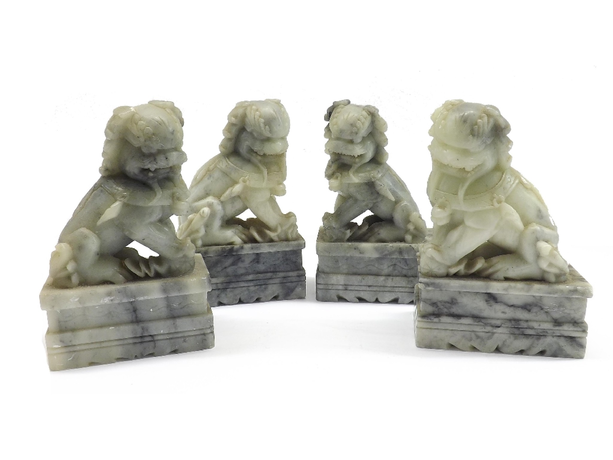 Appraisal: Two opposing pairs of pale and dark stone Chinese Buddhistic