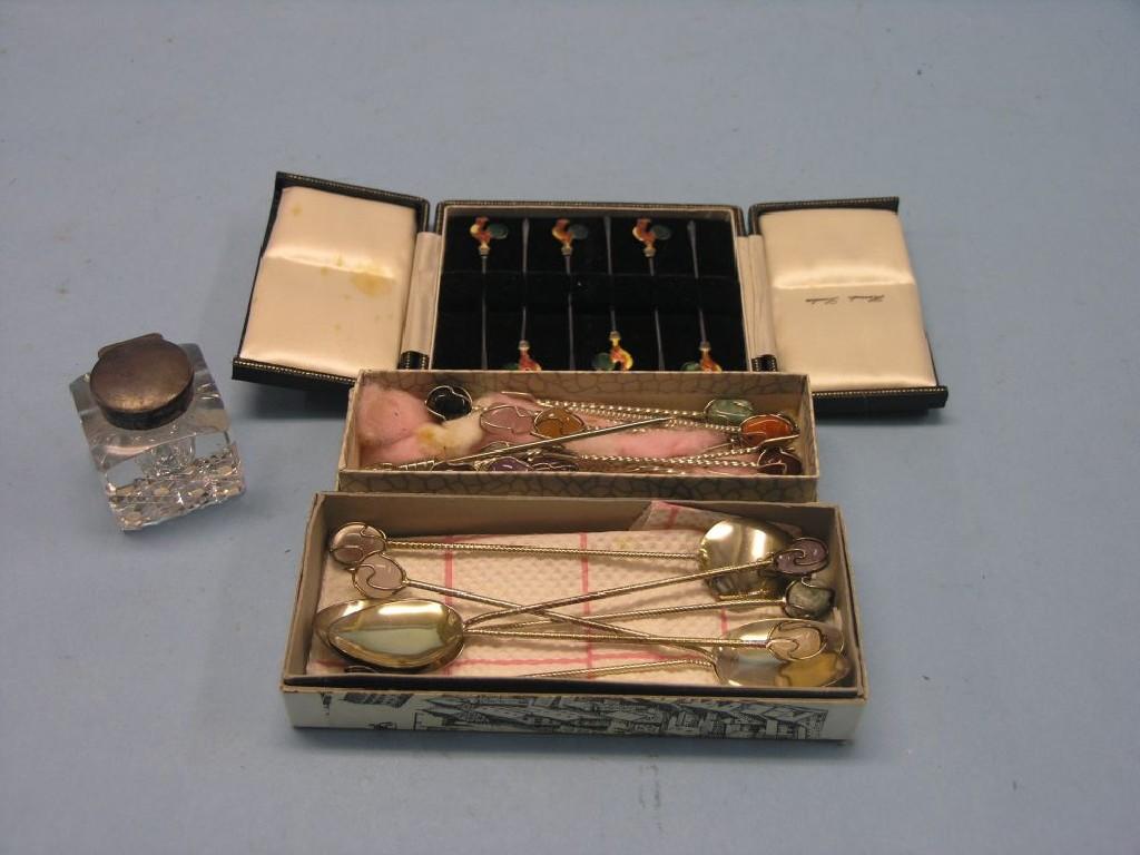 Appraisal: A cased set of six white metal and enamel cocktail