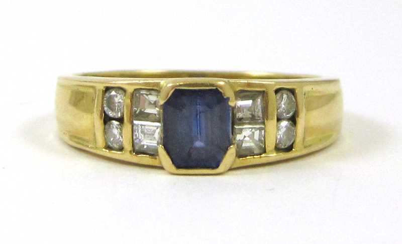 Appraisal: EIGHTEEN KARAT GOLD BLUE SAPPHIRE AND DIAMOND RING the emerald-cut