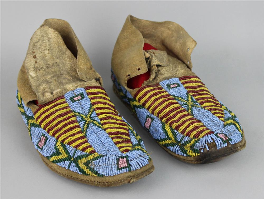 Appraisal: PAIR OF PLAINS BEADED HIDE MOCCASINS sinew sewn parfleche soles