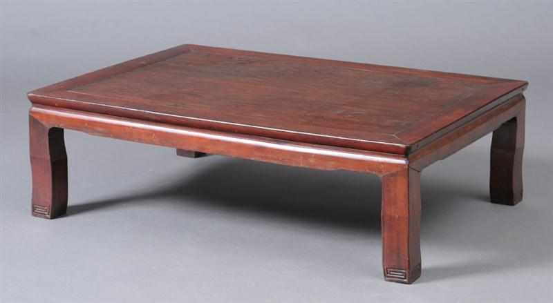 Appraisal: CHINESE RED-STAINED HARDWOOD LOW TABLE The rectangular top on waisted