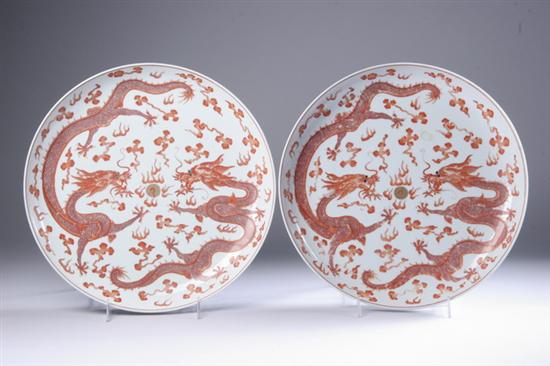 Appraisal: PAIR CHINESE IRON RED AND GILT PORCELAIN DRAGON CHARGERS Guangxu