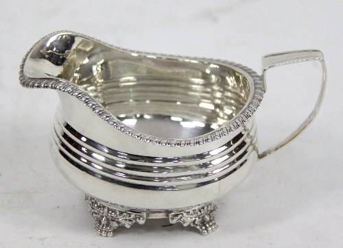 Appraisal: A silver cream jug WH London with gadrooned rim the