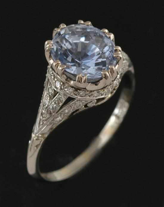 Appraisal: A sapphire and diamond ring Centrally set with an oval