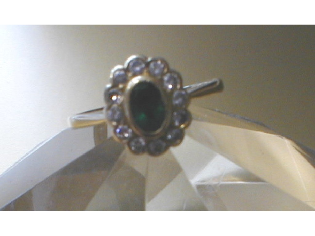 Appraisal: A diamond and emerald cluster ring the central emerald of