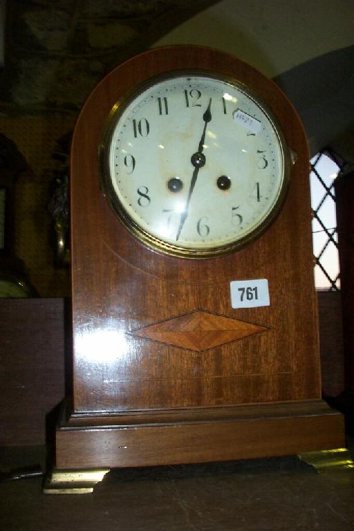 Appraisal: An Edwardian mahogany mantle clock of arched outline enclosing an