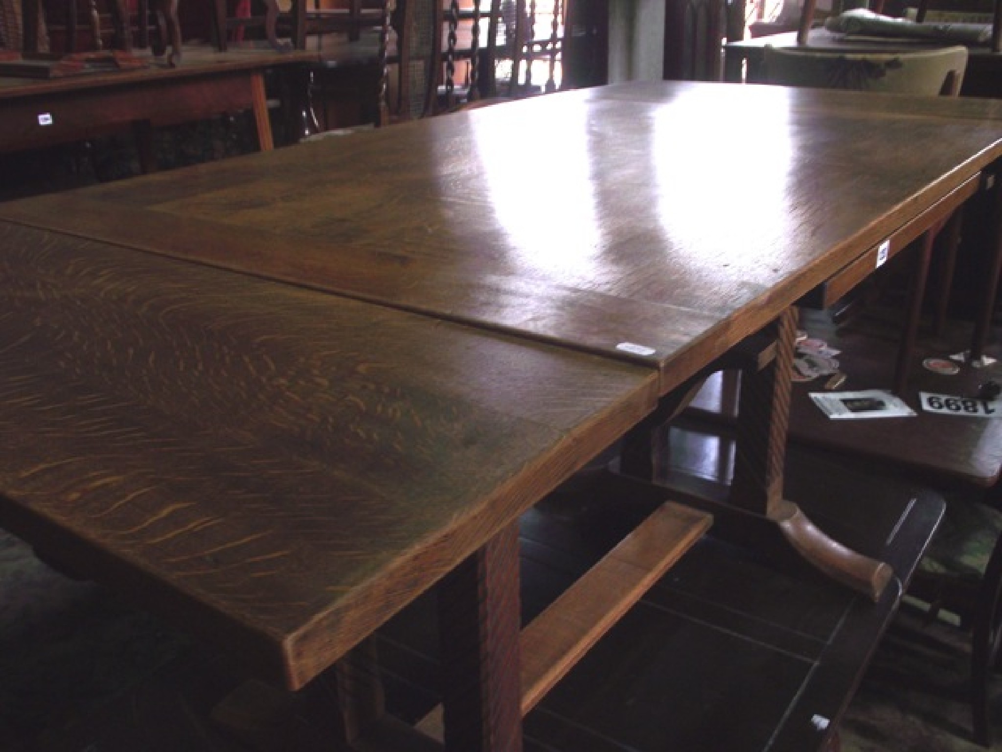 Appraisal: A stripped oak drawerleaf dining table of rectangular form raised