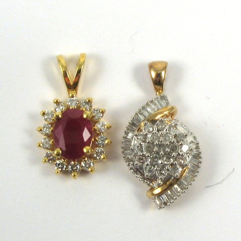 Appraisal: TWO DIAMOND AND GOLD PENDANTS one k yellow gold centering