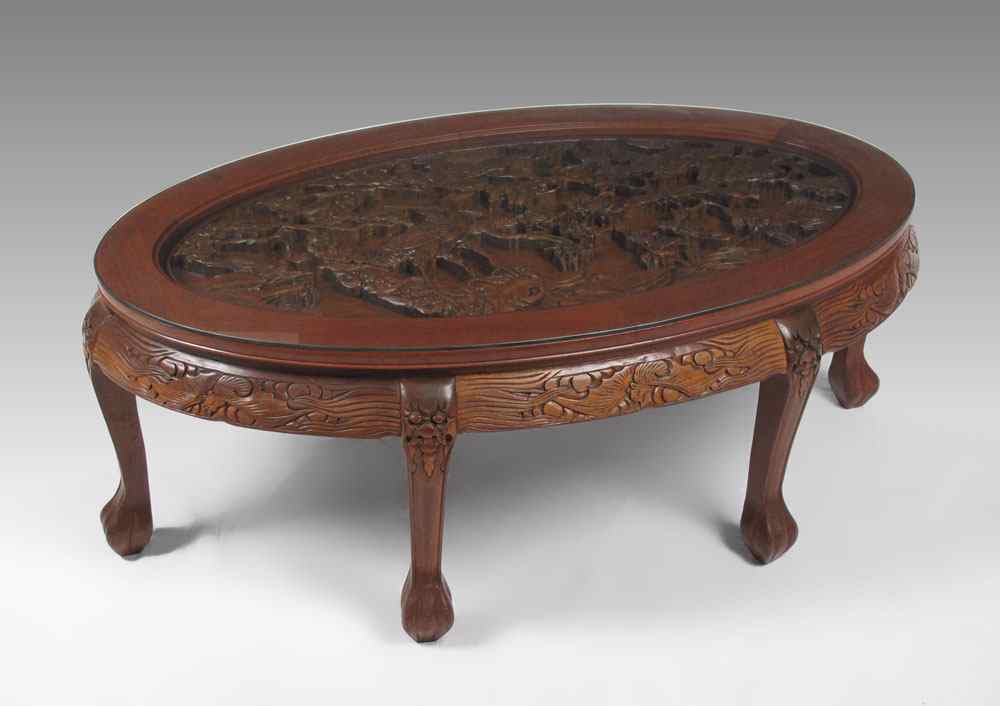 Appraisal: GLASS TOP CARVED ORIENTAL COFFEE TABLE Inset carved panel top