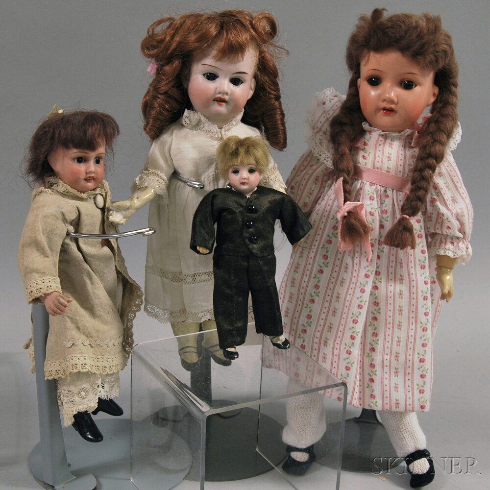 Appraisal: Four Small Bisque Dolls small boy with skin wig composition