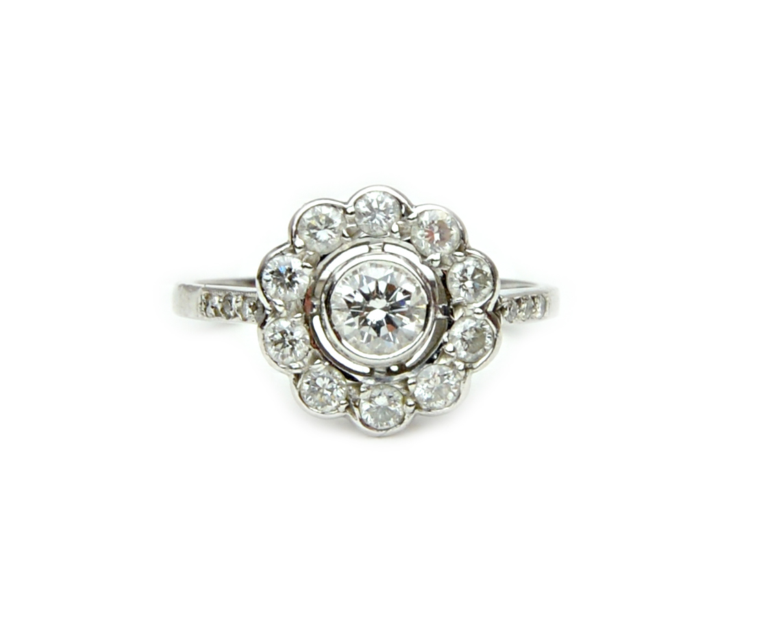 Appraisal: A white gold and diamond cluster ring collet set with